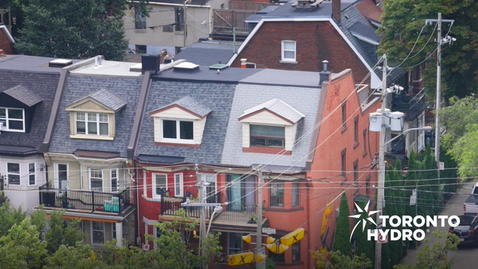 Toronto houses with overhead powerlines running along the street.