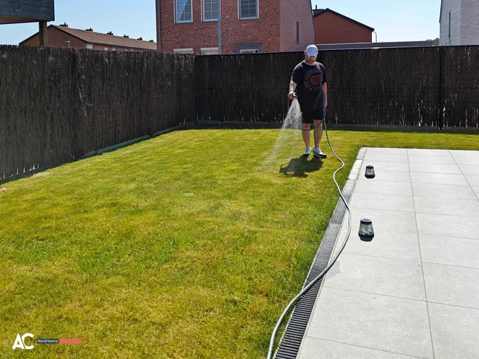 Andreas Christodoulou waters his lawn