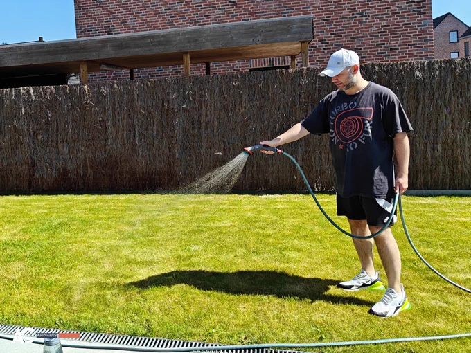 Andreas Christodoulou waters his lawn