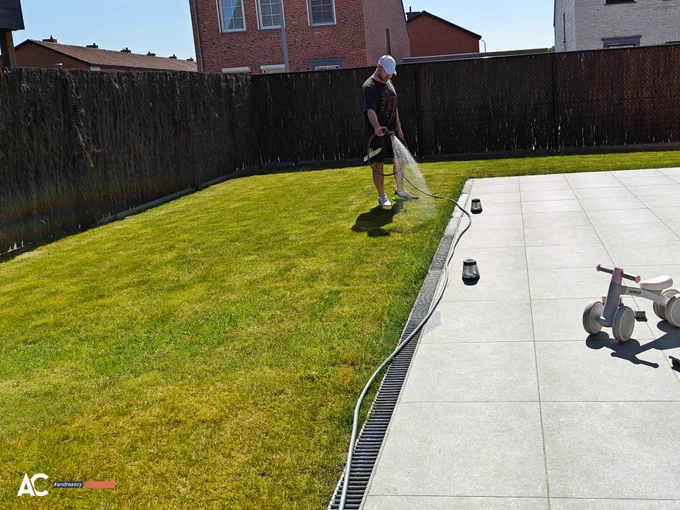 Andreas Christodoulou waters his lawn