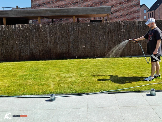 Andreas Christodoulou waters his lawn