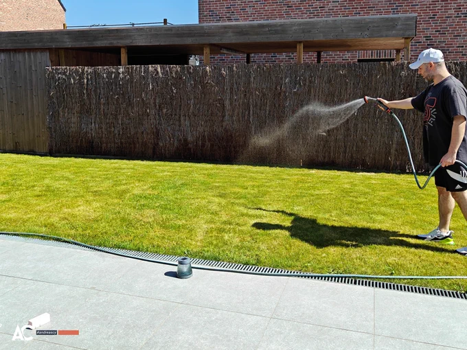 Andreas Christodoulou waters his lawn