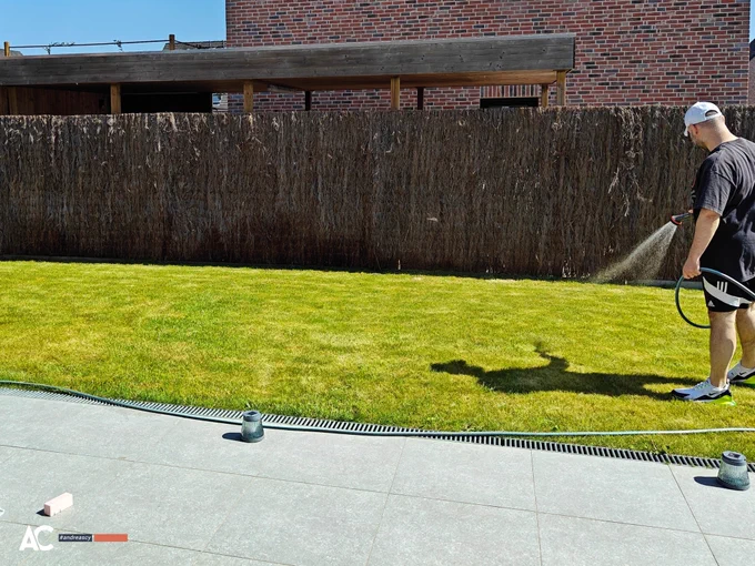 Andreas Christodoulou waters his lawn