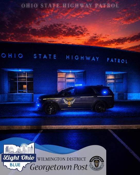 A sunset photo of the Georgetown Patrol Post lit up with blue lights in honor of National Police Week.