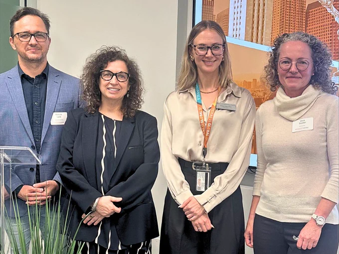 Four people standing indoors in business attire, posing for a group photo. Dr. Marcos Leite, Fulbright Brazil Distinguished Chair in the McKetta Department of Chemical Engineering; Dr. Sonia Feigenbaum, Senior Vice Provost for Global Engagement and Senior International Officer; Holly Schneider, Assistant Director, Global Initiatives; Dr. Vera Tiesler, Fulbright-García Robles Visiting Chair in the Department of Anthropology