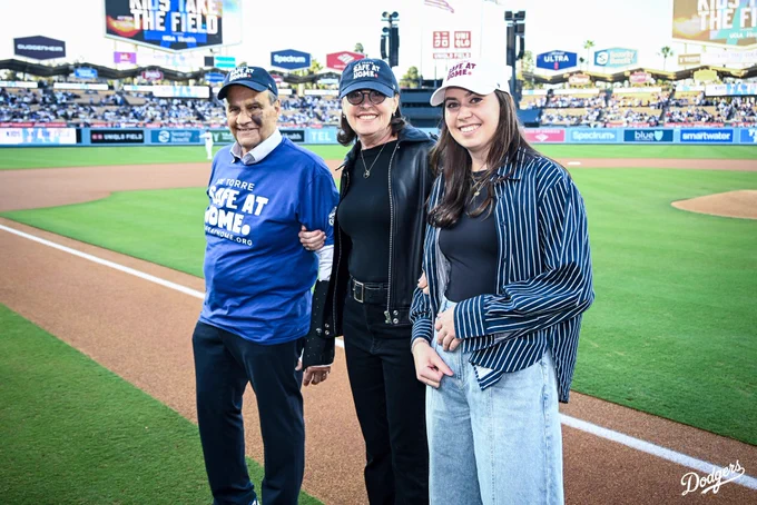 A photo of Joe Torre and the co-founders of Safe at Home on the field being recognized before the game.