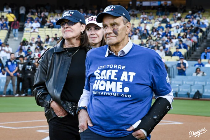 A photo of Joe Torre and the co-founders of Safe at Home on the field before the game.