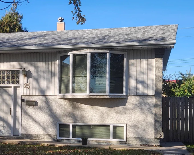 Winnipeg home with bay window replacement and energy-efficient custom windows featuring free triple pane upgrade for improved comfort and savings.
