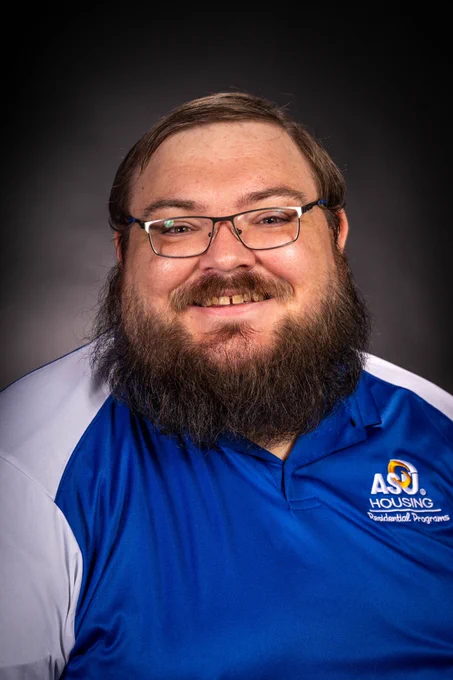 Angelo State University Graduate Hall Director posing for a graduation photo.