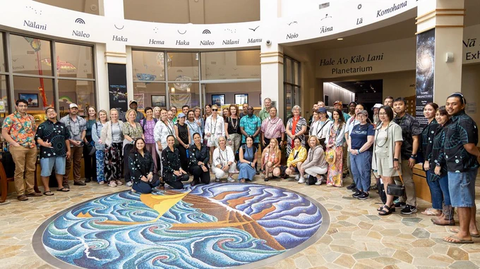 A group of about 50 international diplomats visited ʻImiloa Astronomy Center on May 14, 2026, as part of U.S. Department of Defense program. Chancellor Bonnie Irwin, UH Regent Mike Miyahara, and Institute for Astronomy Doug Simons (center back near pillar) hosted the visit. (Photo: IfA & ʻImiloa)