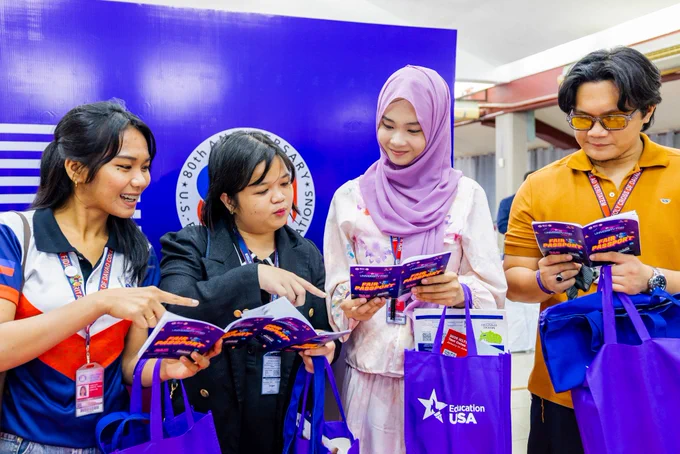 Fair participants looking at their event passports.