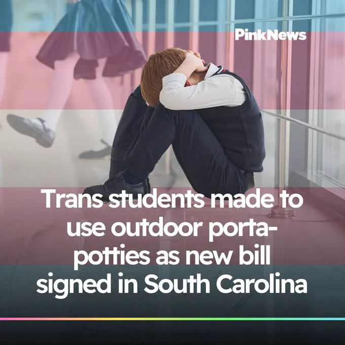 A person sits on the floor with head in hands in a school hallway. In the foreground, there's text: "Trans students made to use outdoor porta-potties as new bill signed in South Carolina." The image is credited to PinkNews.