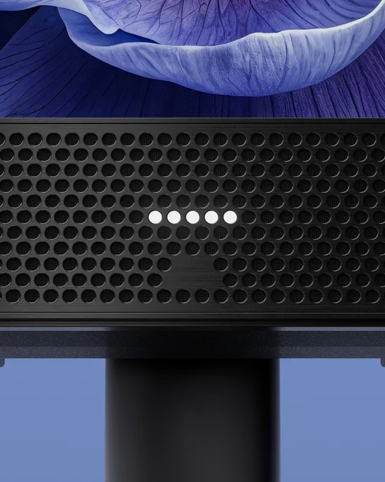 Close-up of a black perforated speaker grille with five illuminated white indicator lights in a horizontal row.