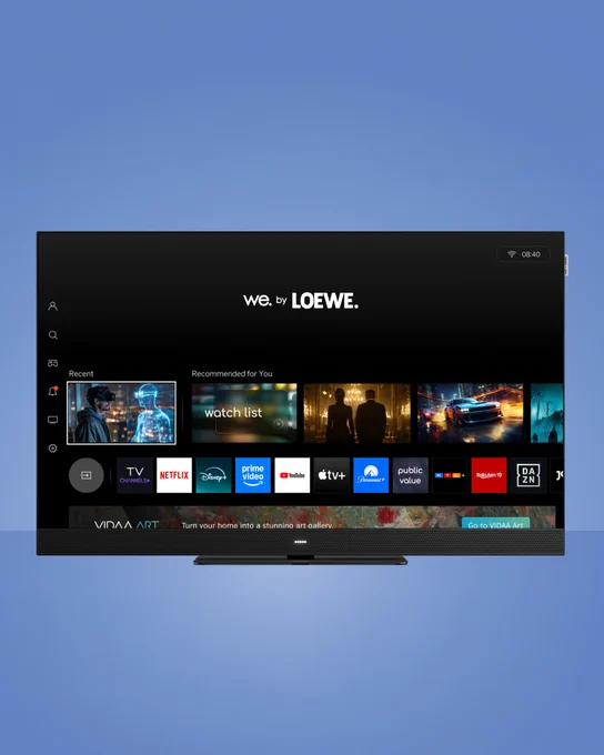 Smart We. SEE lcd TV with home screen displaying streaming apps like Netflix, Disney , Prime Video, and YouTube under the 'We. by Loewe' interface.