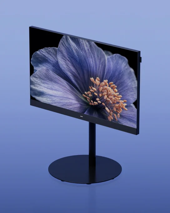 A modern black We. SEE lcd  television on a black floor stand against a blue background, showing a high-resolution image of a purple flower with orange stamens.