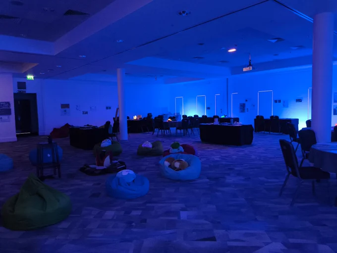 Dim lit Reset Room with bean bags and activity tables