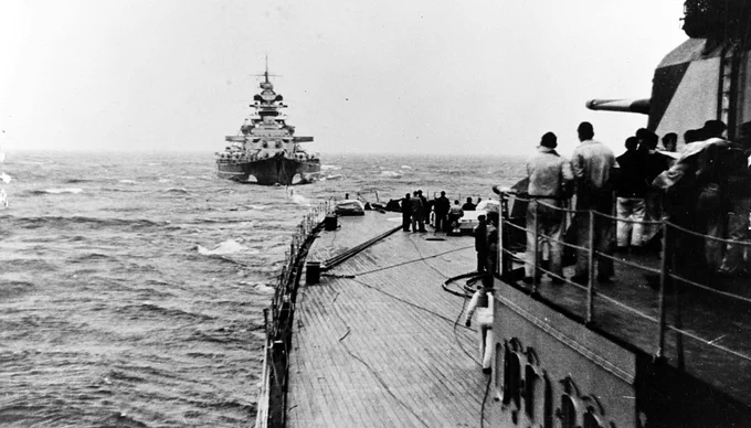 Bsttleship Bismarck seen astern of the heavy cruiser Prinz Eugen as they practice towing and refuelling by trailing hose. Taken sometime in April/May 1941. Photo: US NHHC.