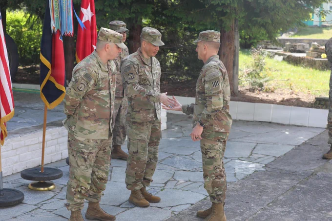 U.S. Army Maj. Gen. John Lubas, Commanding General of 3rd Infantry Division, awards Master Sgt. Michael Jenkins and Sgt. 1st Class. Matthew Rivera a new division coin during a ceremony