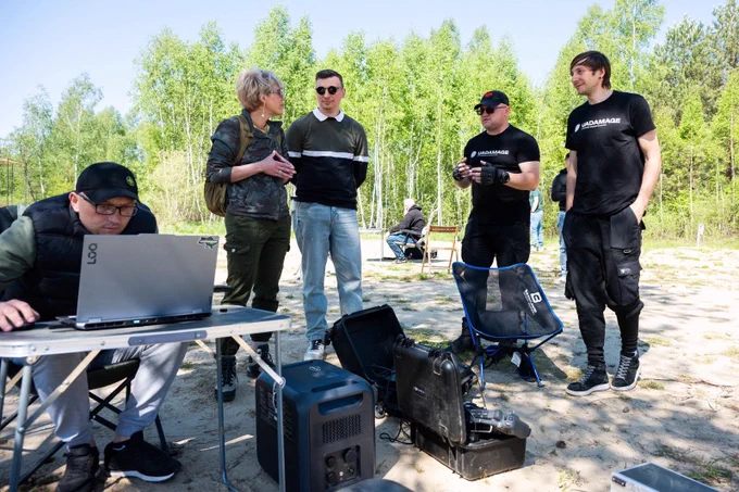 Representatives of UADamage and partners take part in a field demonstration.