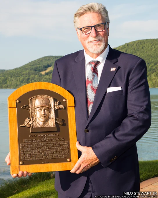 Jack Morris holds his Hall of Fame plaque as he stands on the banks of Otsego Lake. (Milo Stewart Jr./National Baseball Hall of Fame and Museum)
