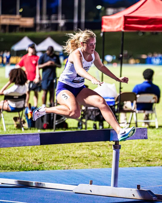 Faithe Ketchum clearing a hurdles in the steeplechase.