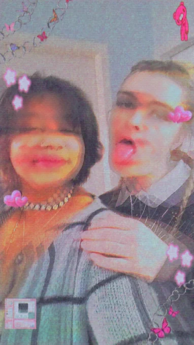A picture of Ames and Quick all dressed up to go out. There is a distortion filter on the image and pink hearts