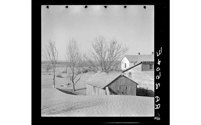 Soil blown by "dust bowl" winds piled up in large drifts near Liberal, Kansas. Photographer Arthur Rothstein, Library of Congress.