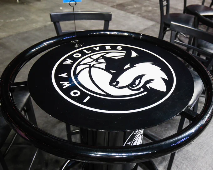 A black high top table with the Iowa Wolves logo in white at the center. 