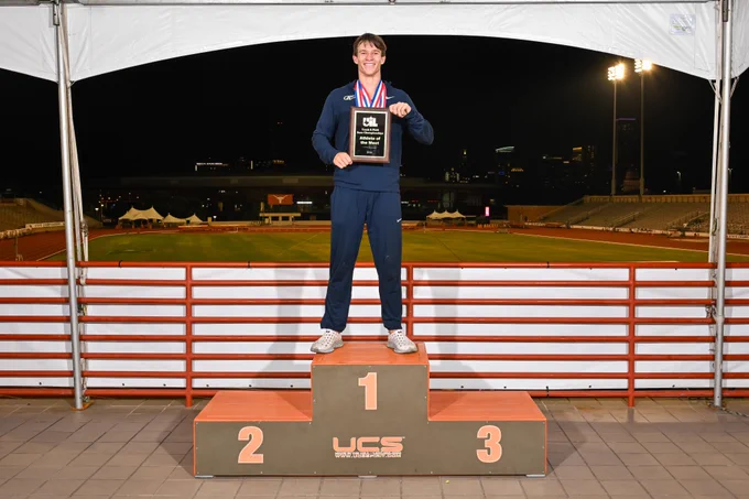Andrew Jones posed with award plaque.