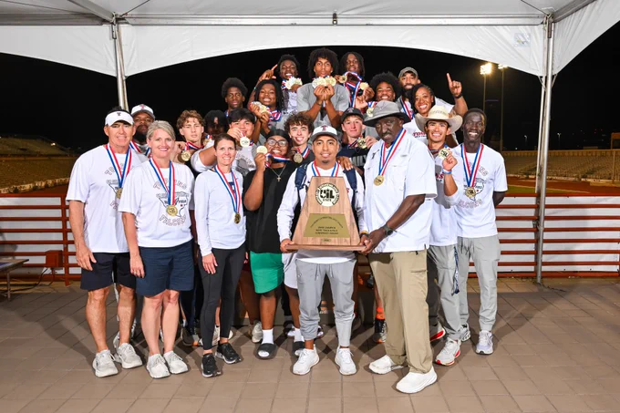 Katy Tompkins team and coaches pose with championship trophy on award stand.