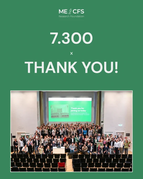 The image shows a large group of over 100 people gathered in a conference room, standing and applauding in front of a screen displaying the message "Thank you for joining us today".