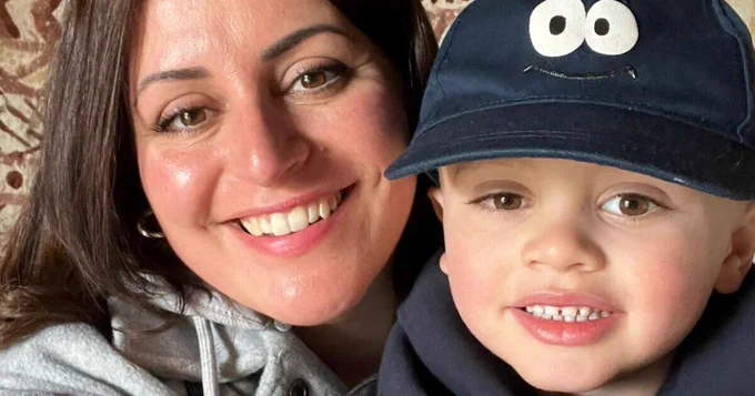 Isaac and his mum are smiling in a selfie together