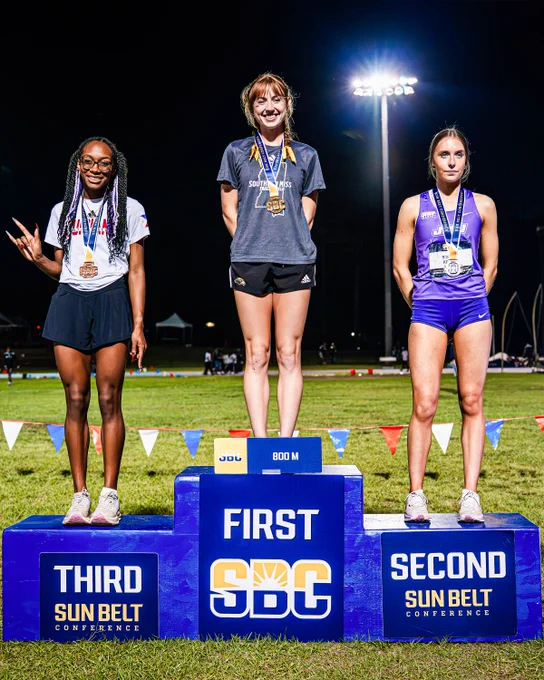 Bridget Koller and fellow 800-meter participants standing on the podium.