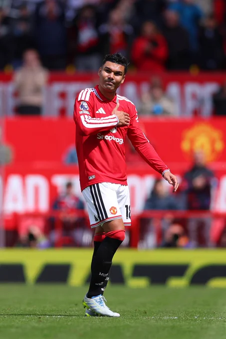 Casemiro taps the United badge as he leaves the field in his final Old Trafford appearance for the Reds.