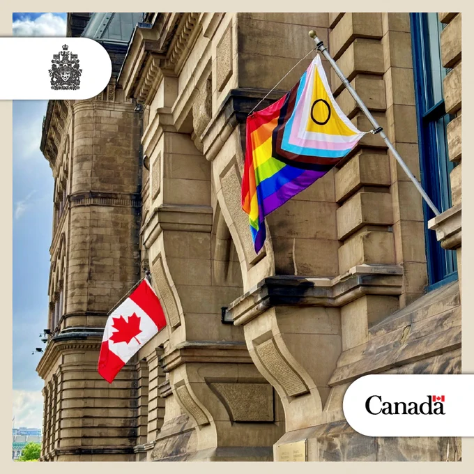 The Intersex-Inclusive Pride and Canada flags wave on the side of the Office of the Prime Minister and Privy Council in Ottawa, Ontario.