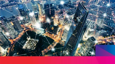 Aerial night view of a city skyline with illuminated skyscrapers connected by glowing digital network lines.
