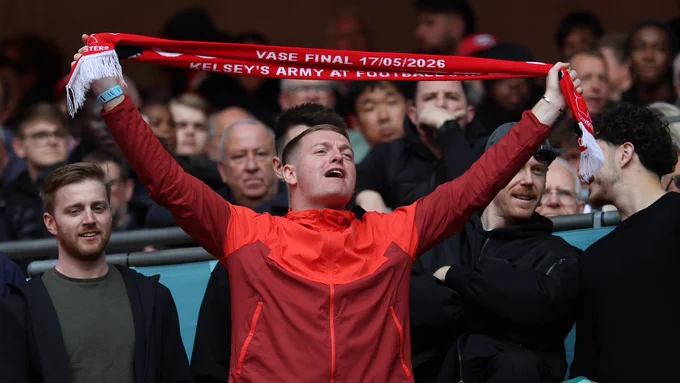 A Cockfosters fan holds up a scarf during the Isuzu FA Vase Final.