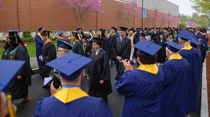 The Golden Graduates clap for the Class of 2026 at Merrimack College.