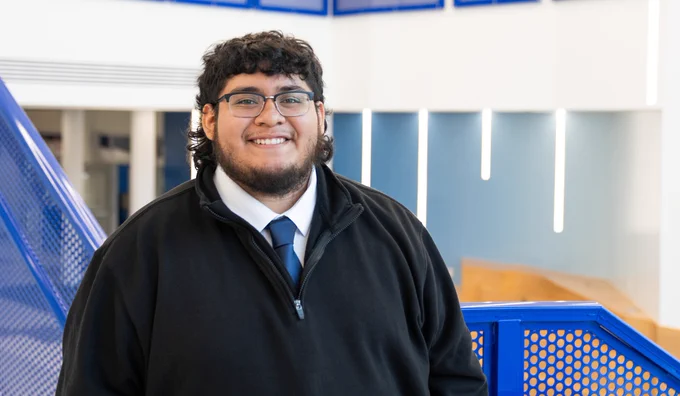 a photo of a student smiling for a photo