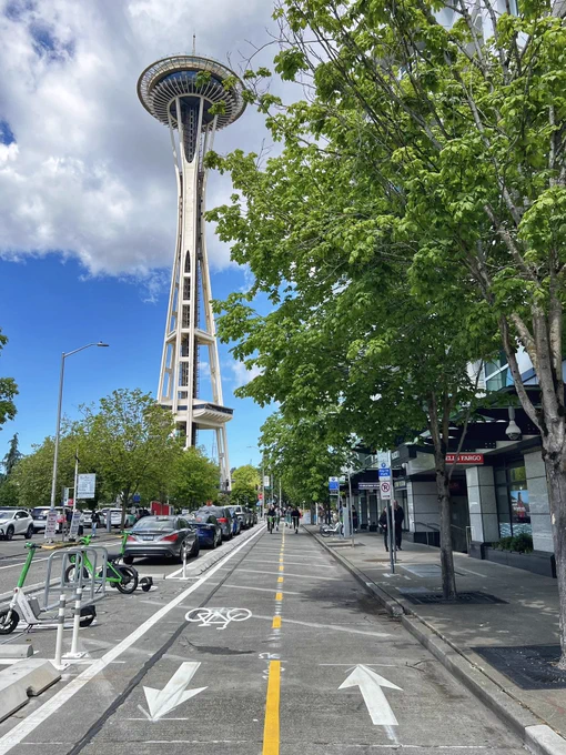 Photo by me. Taken today. Bike lane with a crowd of micromobility users in the background.