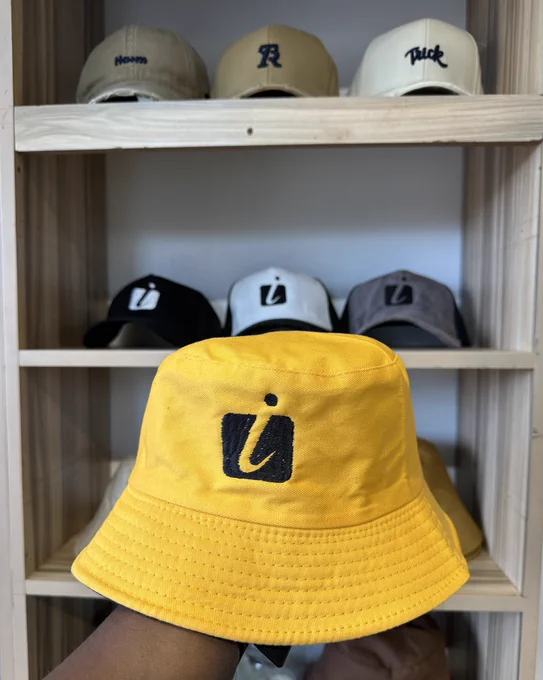 Mustard yellow bucket hat. UGX 30,000/=