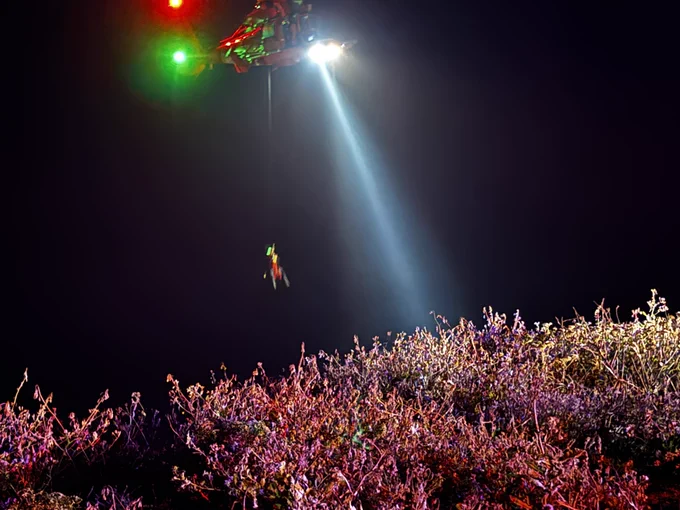Person hoisted by helicopter