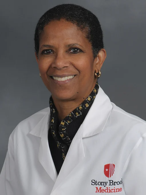 An individual wearing a white lab coat with the Stony Brook Medicine logo.