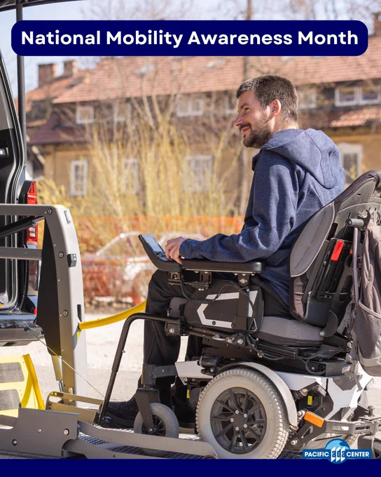 Person in a motorized wheelchair using a vehicle lift outdoors during National Mobility Awareness Month.
