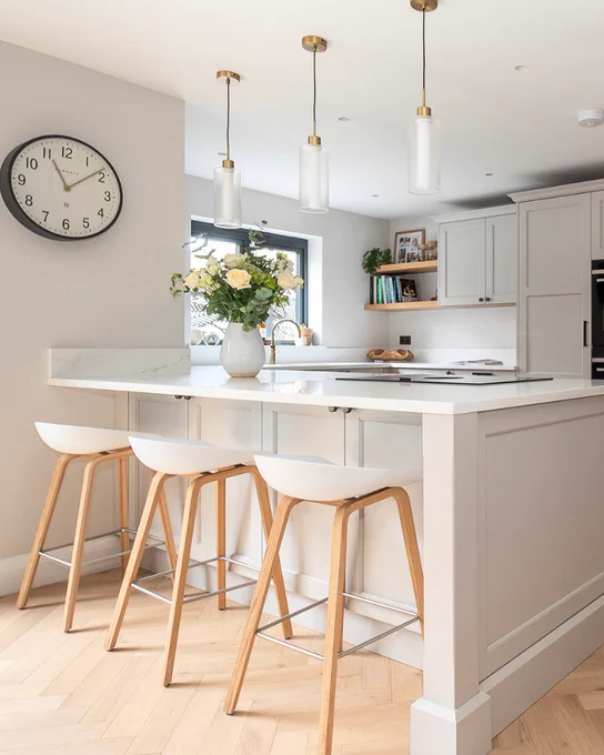 White peninsula island with wooden stools 