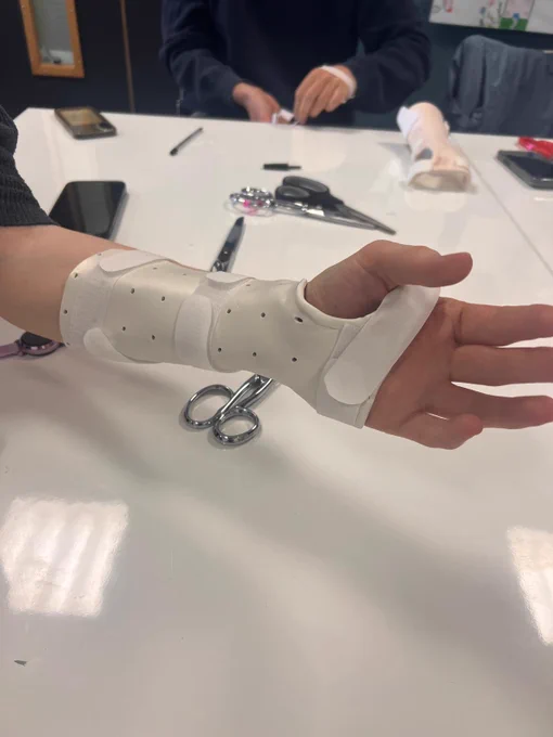 Image shows a student arm from hand to elbow wearing a splint.
