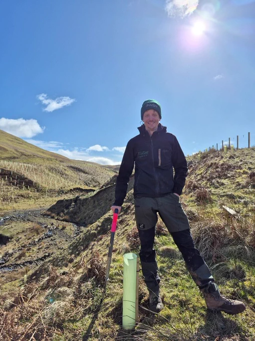 Keith of Treeline Woodlands Ltd planting the last tree