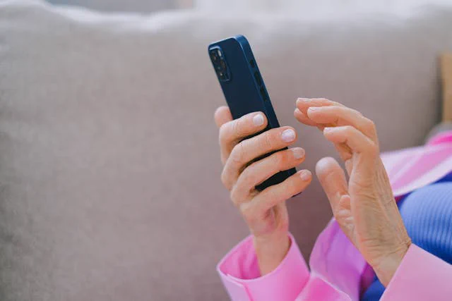 A person’s hands holding a smartphone
