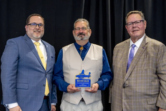 Photographer, Ken Beachler from Marketing & Communications receives an Excellence Award from RSC President Travis Hurst and RSC Board of Regents Chair Bill Croak.
 