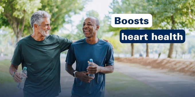 Two older men walking outdoors holding water bottles, promoting heart health benefits.